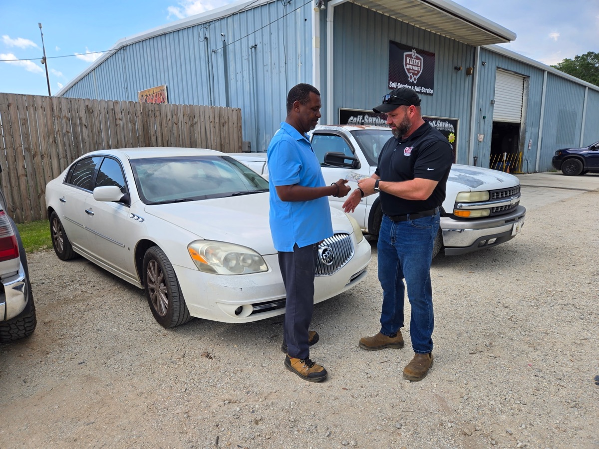 Kiker's completing a cash vehicle purchase with a customer