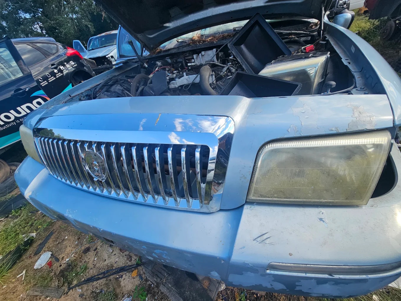 Grille and headlight parts ready to be removed from a vehicle