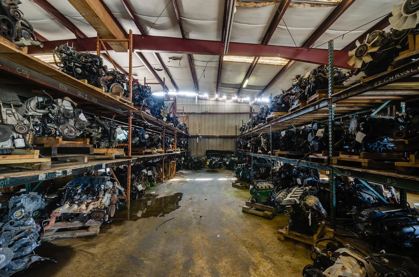 Engines and drivetrain parts organized inside Kiker's full-service warehouse